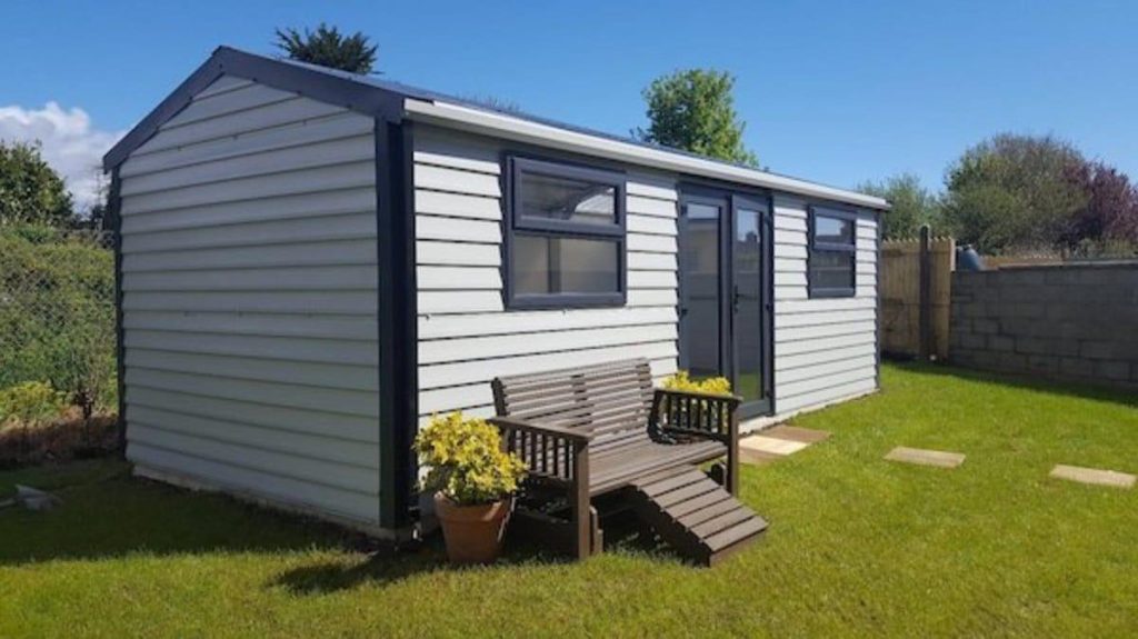 Aspen shed grey in color in back garden Shouteast stell sheds